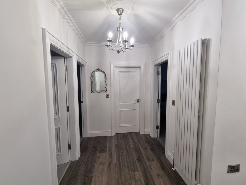 Bright white interior hallway painted by expert painters in Portstewart, showcasing professional wall and door finishes. Ideal for home interior painting and renovation projects.