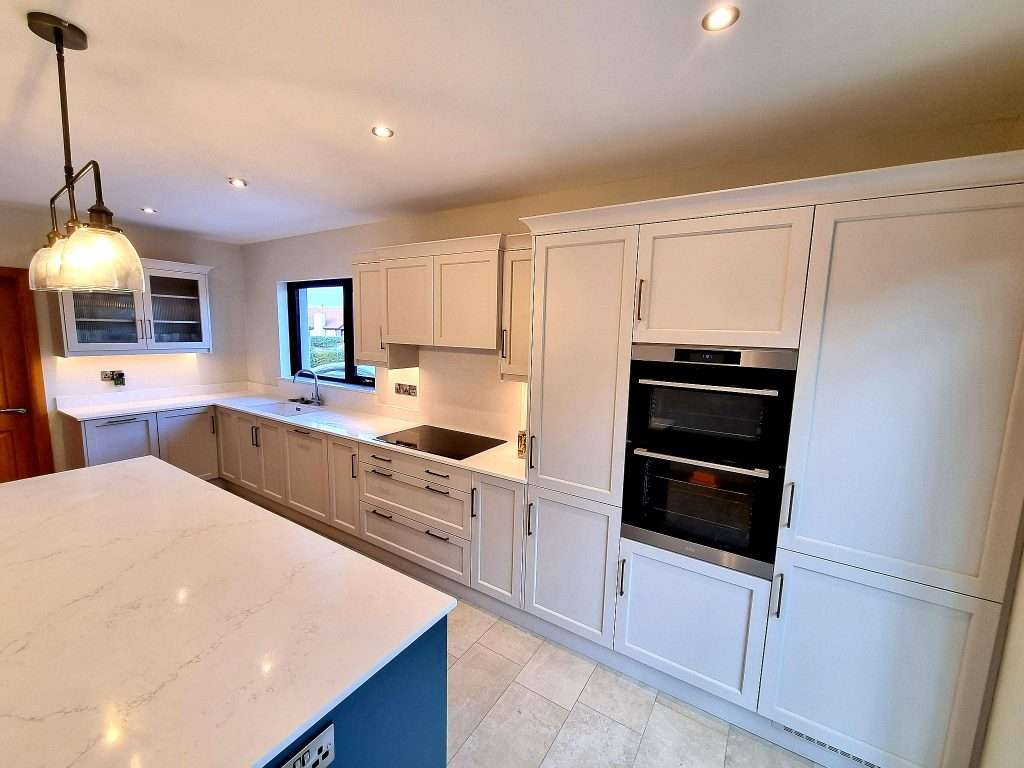 Bright white kitchen cabinets installed by professional interior painters in Portstewart, showcasing expert kitchen painting services.