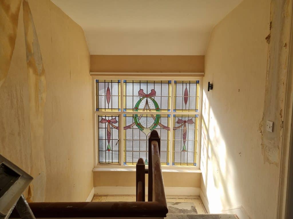 Bright interior hallway with stained glass window