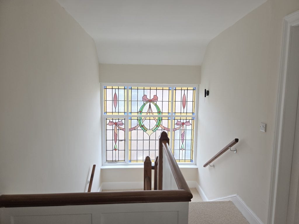 Staircase with stained glass and interior walls in portstewart